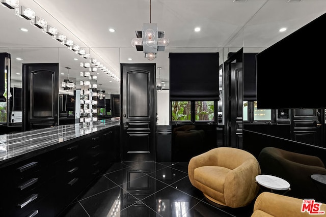 kitchen with dark tile patterned flooring and stone countertops