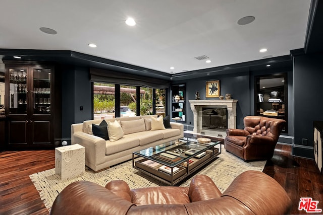 living room with hardwood / wood-style floors and a high end fireplace