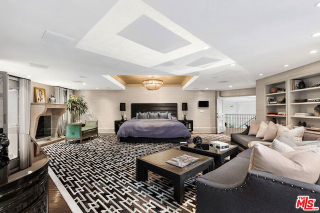 bedroom with hardwood / wood-style flooring and a notable chandelier