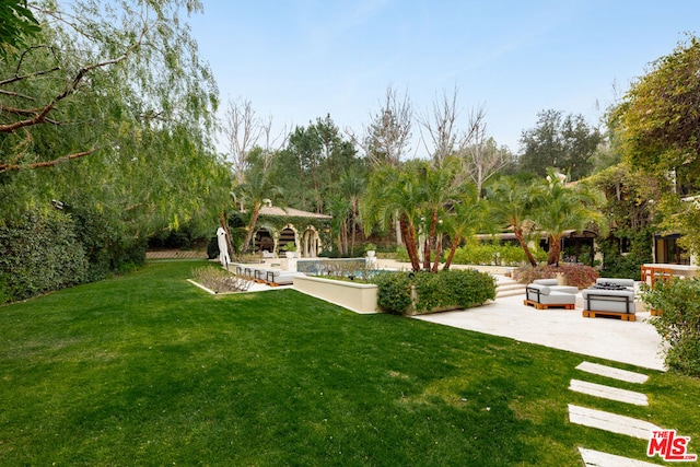 view of yard featuring a gazebo and a patio area