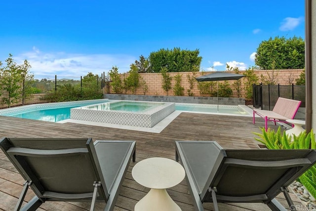 view of pool with an in ground hot tub and a deck