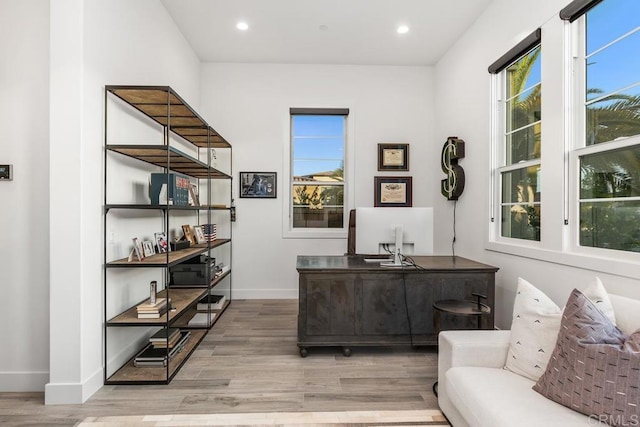 home office featuring light wood-type flooring and a wealth of natural light