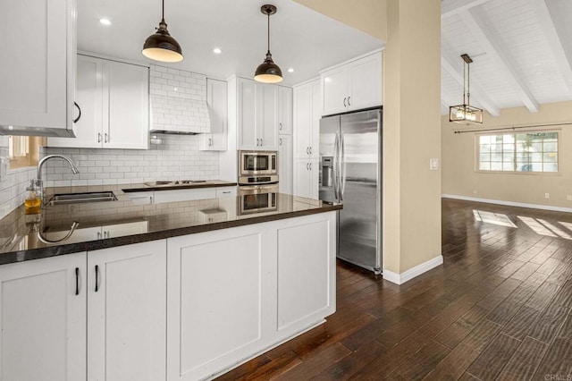 kitchen featuring sink, white cabinetry, hanging light fixtures, appliances with stainless steel finishes, and decorative backsplash