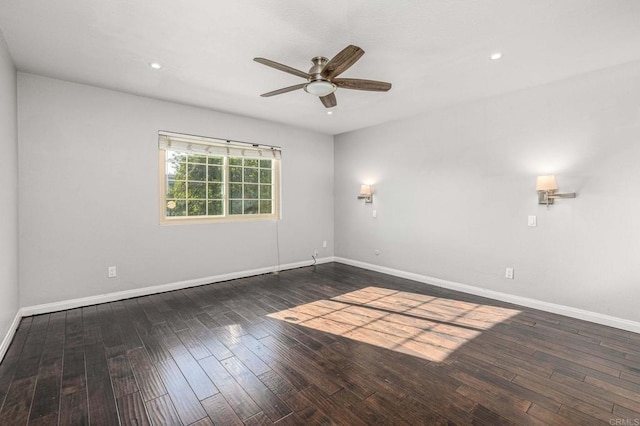 spare room featuring dark hardwood / wood-style floors and ceiling fan