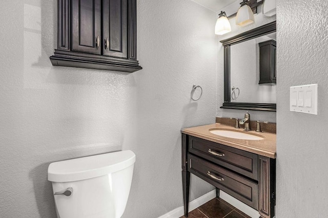 bathroom featuring vanity, tile patterned floors, and toilet