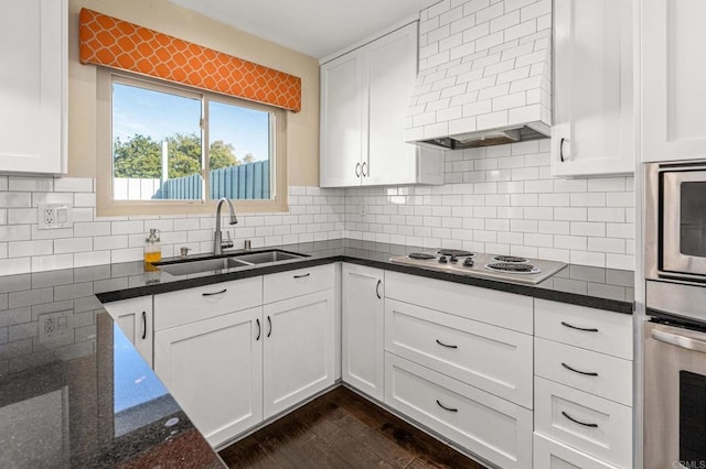 kitchen with sink, oven, and white cabinets