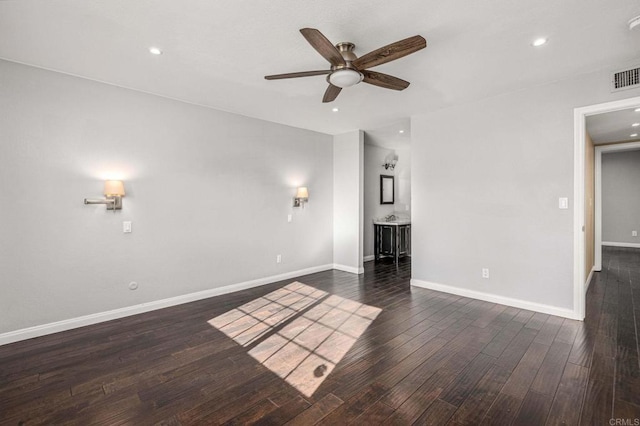 unfurnished living room featuring dark hardwood / wood-style flooring and ceiling fan