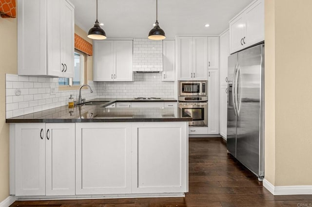 kitchen featuring sink, white cabinets, hanging light fixtures, kitchen peninsula, and stainless steel appliances