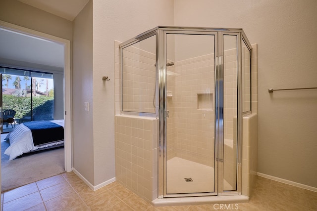 bathroom featuring a shower with door and tile patterned floors