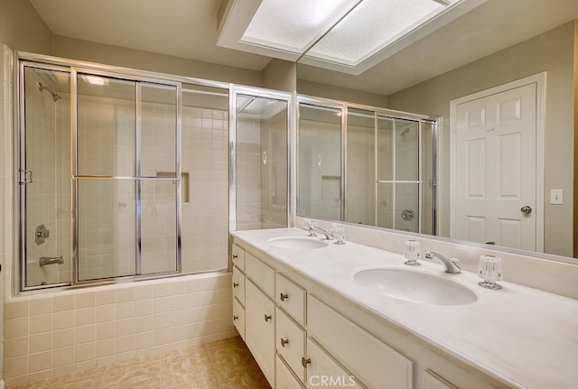 bathroom with tile patterned flooring, vanity, and enclosed tub / shower combo