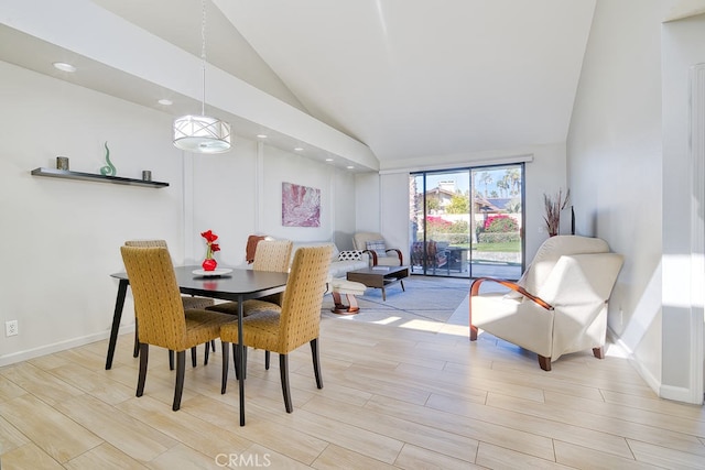 dining area featuring high vaulted ceiling