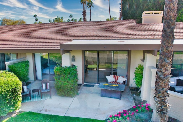 back of house with a patio area and an outdoor fire pit