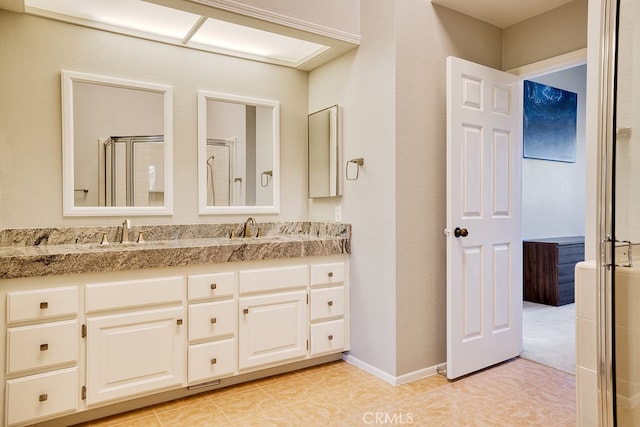 bathroom featuring vanity, tile patterned floors, and walk in shower