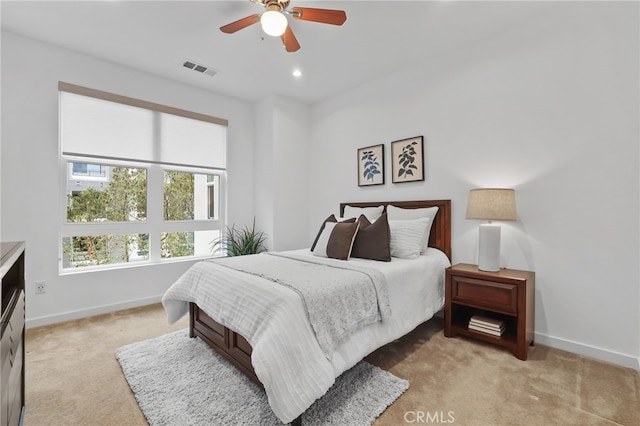 bedroom featuring light carpet and ceiling fan