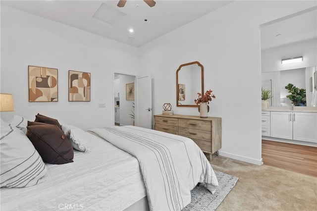 carpeted bedroom with ceiling fan and ensuite bathroom