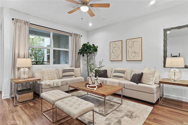 living room with hardwood / wood-style flooring and ceiling fan