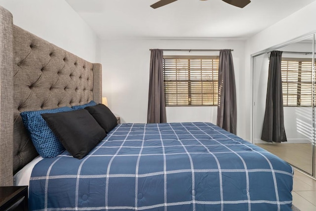 tiled bedroom featuring ceiling fan