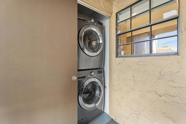 washroom featuring stacked washer and dryer