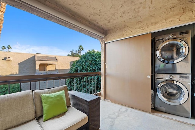 clothes washing area with stacked washer / dryer and plenty of natural light