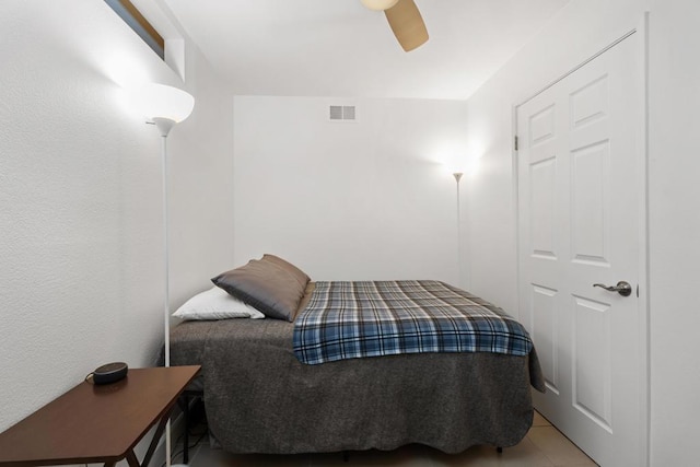 tiled bedroom with ceiling fan