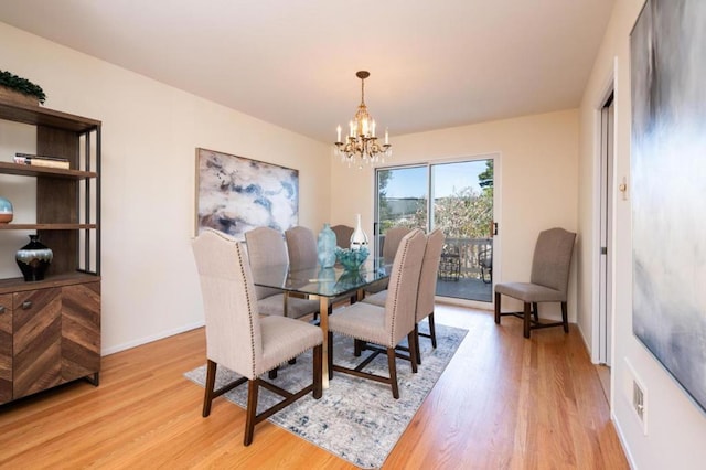 dining room with a chandelier and light wood-type flooring