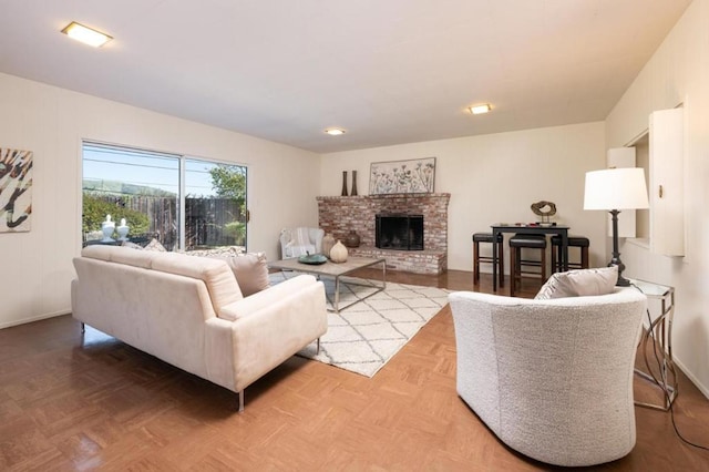 living room with a brick fireplace and parquet floors