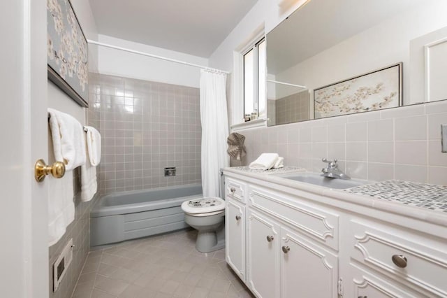 full bathroom with shower / tub combo with curtain, tile walls, vanity, toilet, and tile patterned floors