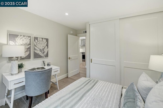 bedroom featuring a closet and light hardwood / wood-style flooring