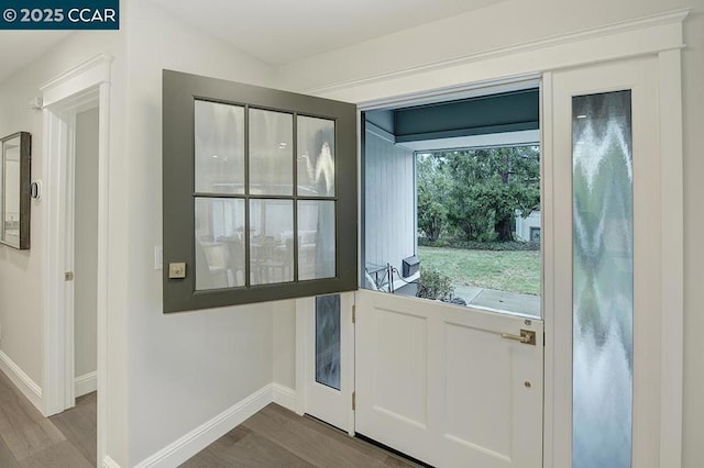 doorway to outside with wood-type flooring