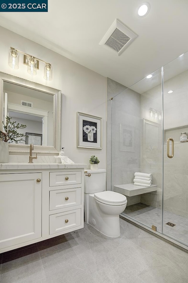 bathroom with vanity, toilet, and walk in shower