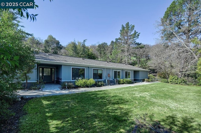 view of front of property with a front lawn and central air condition unit