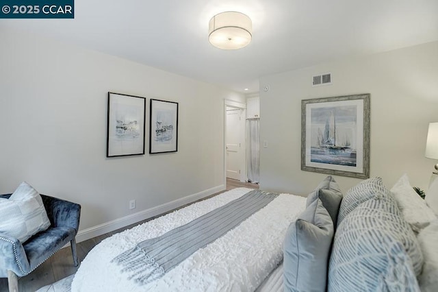 bedroom with hardwood / wood-style flooring