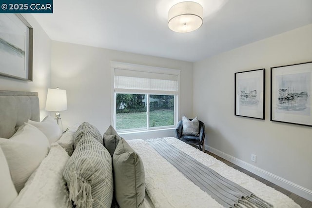 bedroom with dark hardwood / wood-style flooring