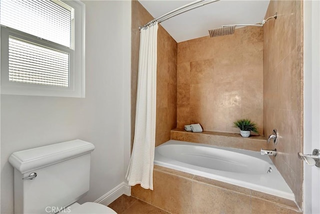 bathroom with shower / tub combo with curtain, tile patterned floors, and toilet