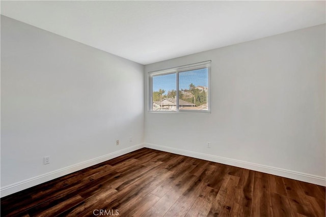 unfurnished room featuring dark hardwood / wood-style flooring