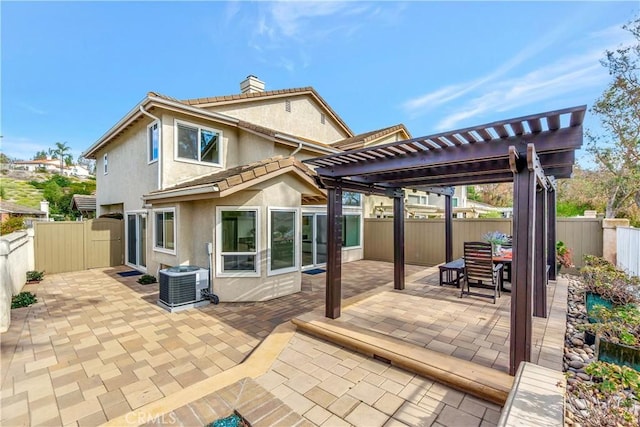 back of property with a patio, central air condition unit, and a pergola