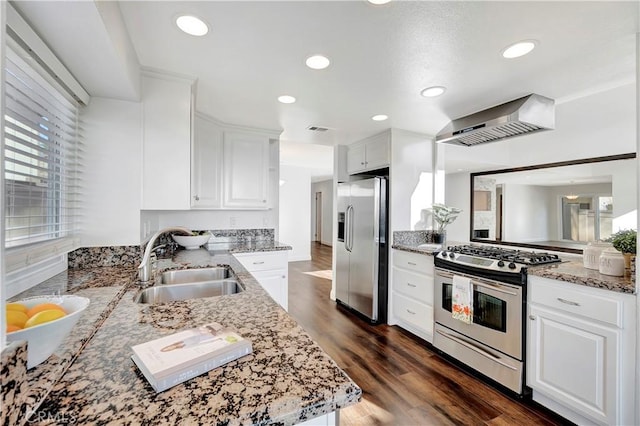 kitchen featuring stainless steel appliances, white cabinetry, sink, and kitchen peninsula