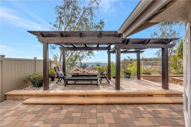 wooden terrace featuring a pergola and a patio area