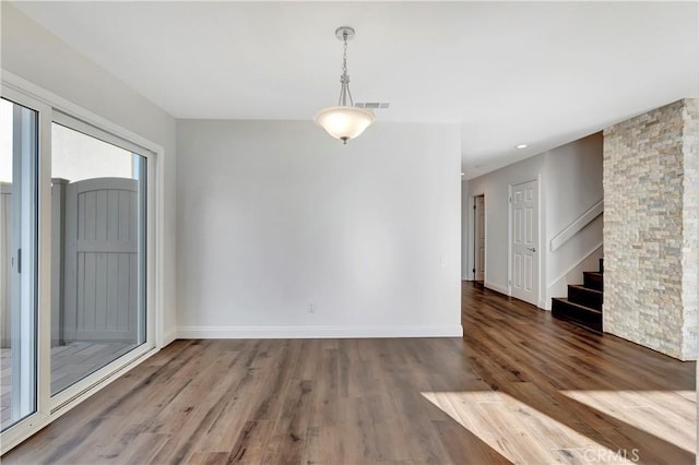 spare room featuring wood-type flooring