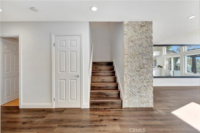 stairs with hardwood / wood-style flooring