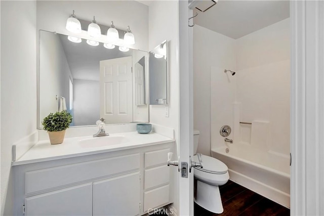 full bathroom featuring vanity, wood-type flooring, toilet, and washtub / shower combination