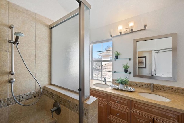 bathroom featuring tasteful backsplash, vanity, and tiled shower