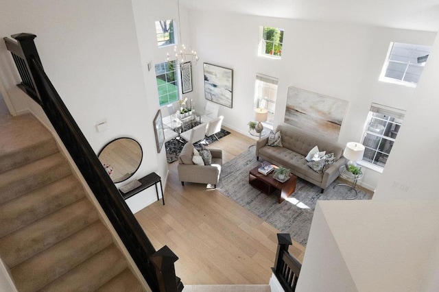 living room with light hardwood / wood-style floors and a high ceiling