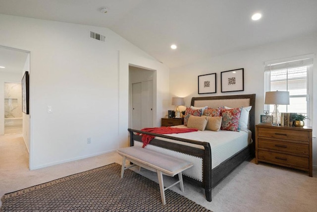 bedroom featuring lofted ceiling and light carpet