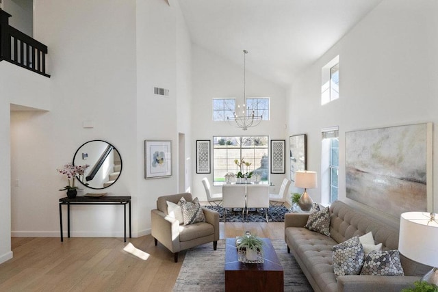 living room featuring wood-type flooring and a chandelier