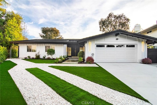 ranch-style home featuring a garage and a front yard