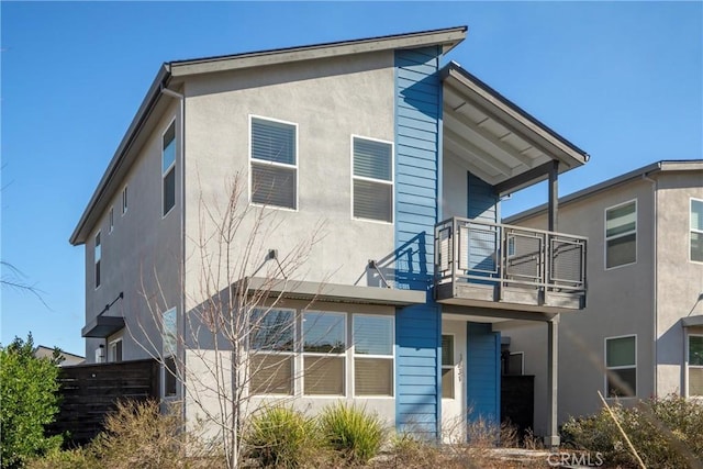 rear view of property featuring a balcony