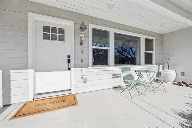 entrance to property featuring covered porch