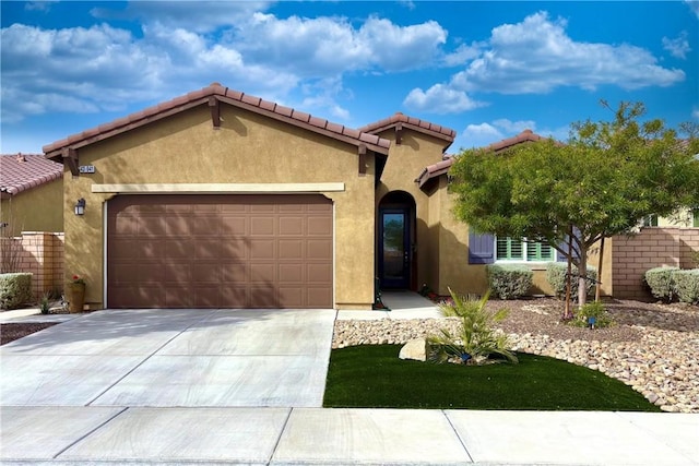 mediterranean / spanish-style house with a garage