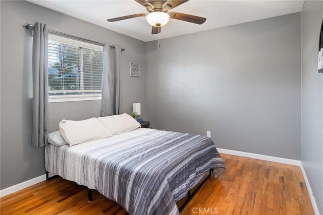 bedroom with hardwood / wood-style flooring and ceiling fan